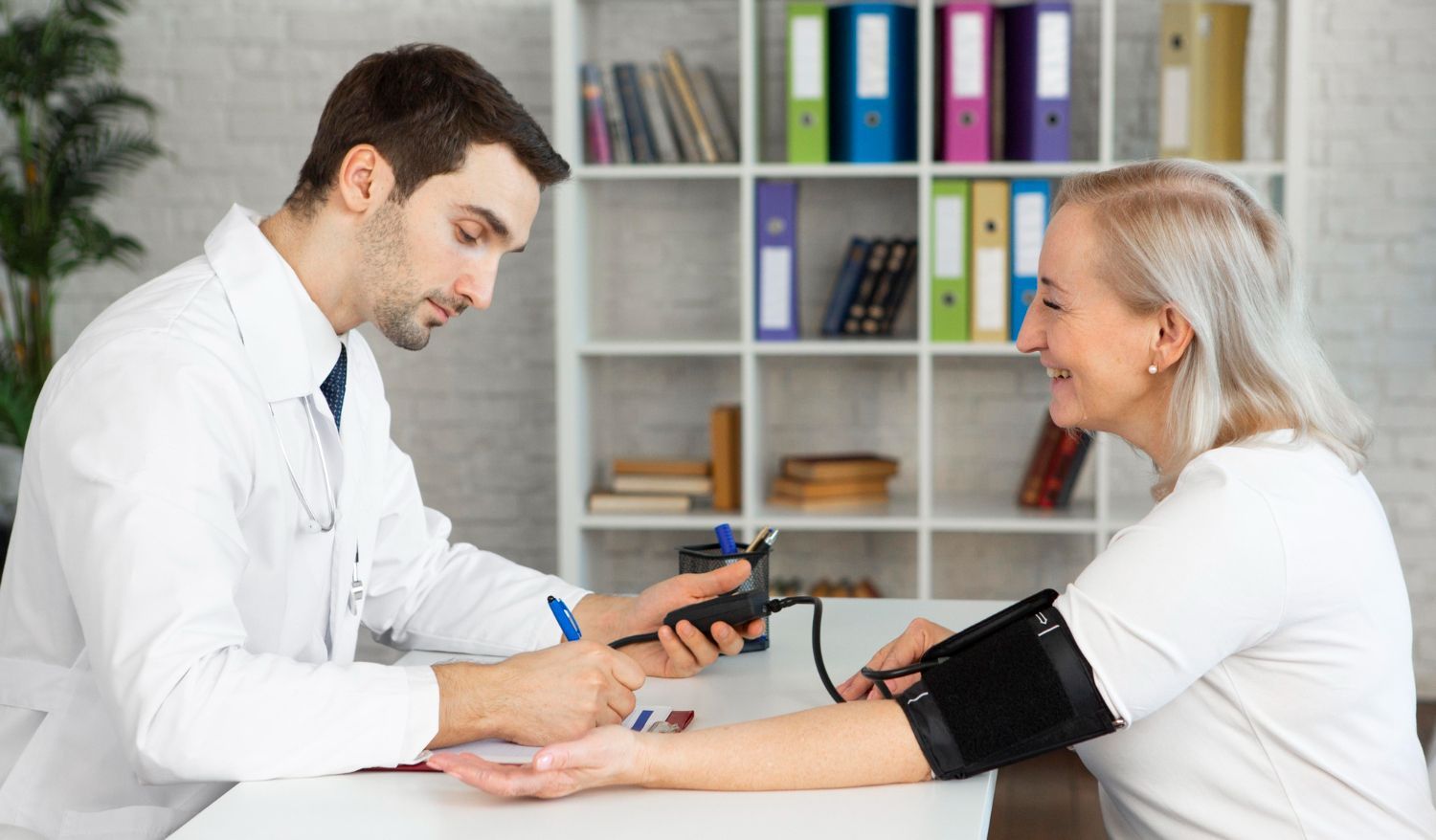 Doctor taking blood pressure of a patient in a clinic office