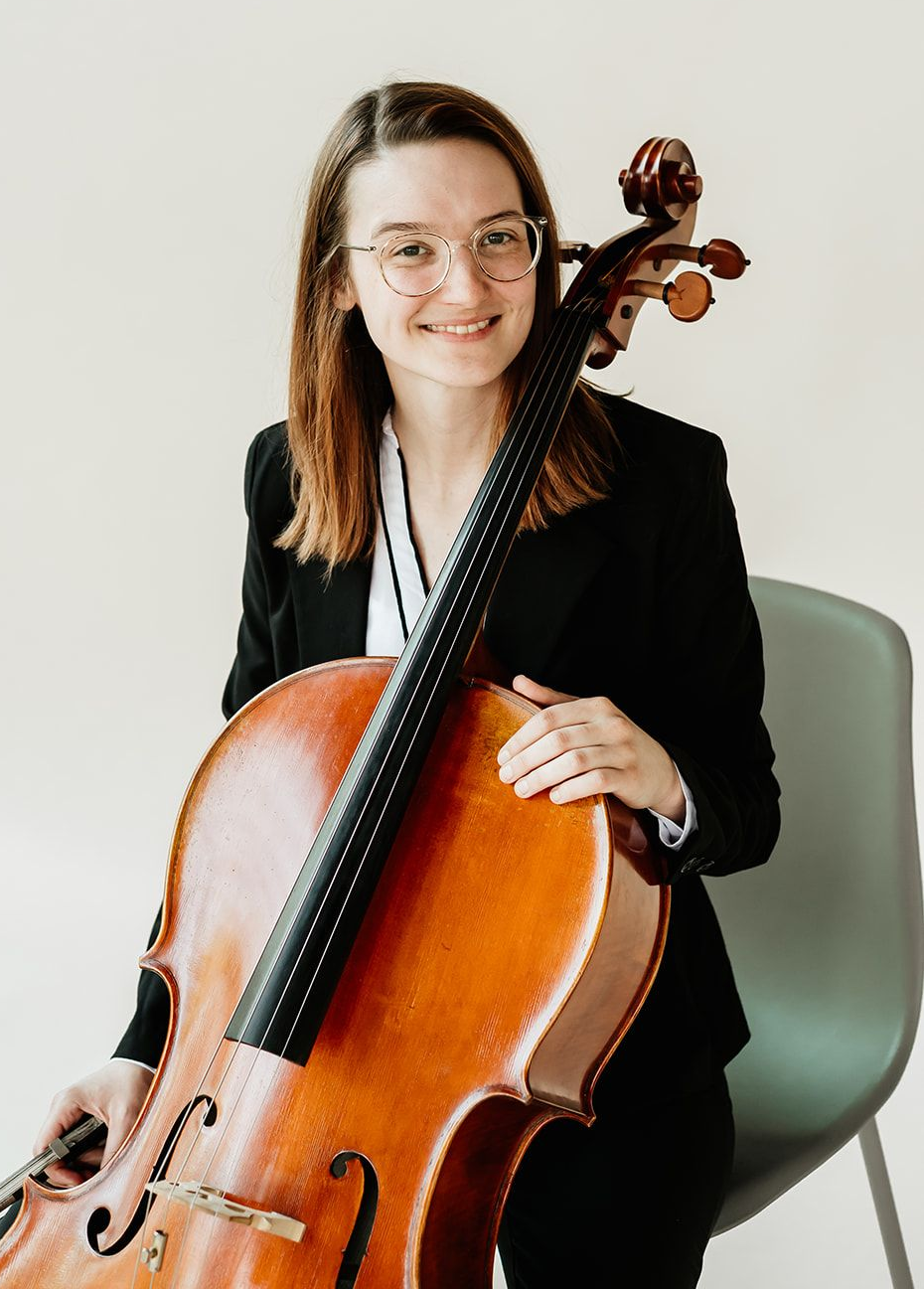 A woman is holding a cello