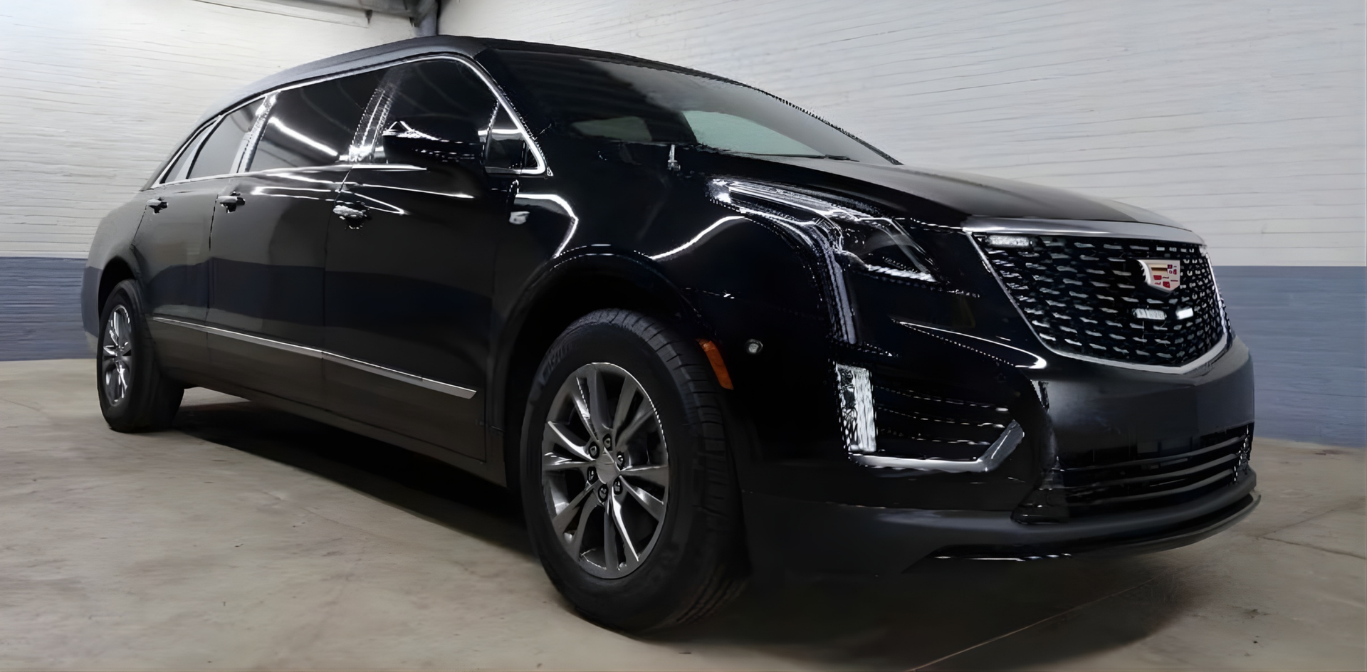 Black Cadillac SUV parked indoors.