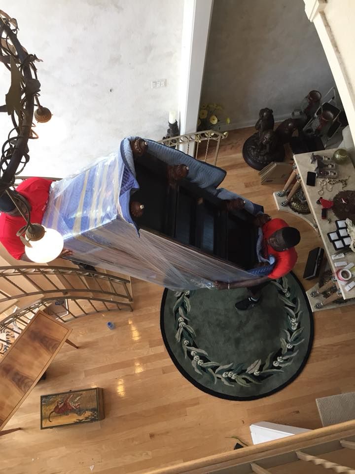 An aerial view of a piano being moved in a living room. 28.4845° N, 81.2519° W
