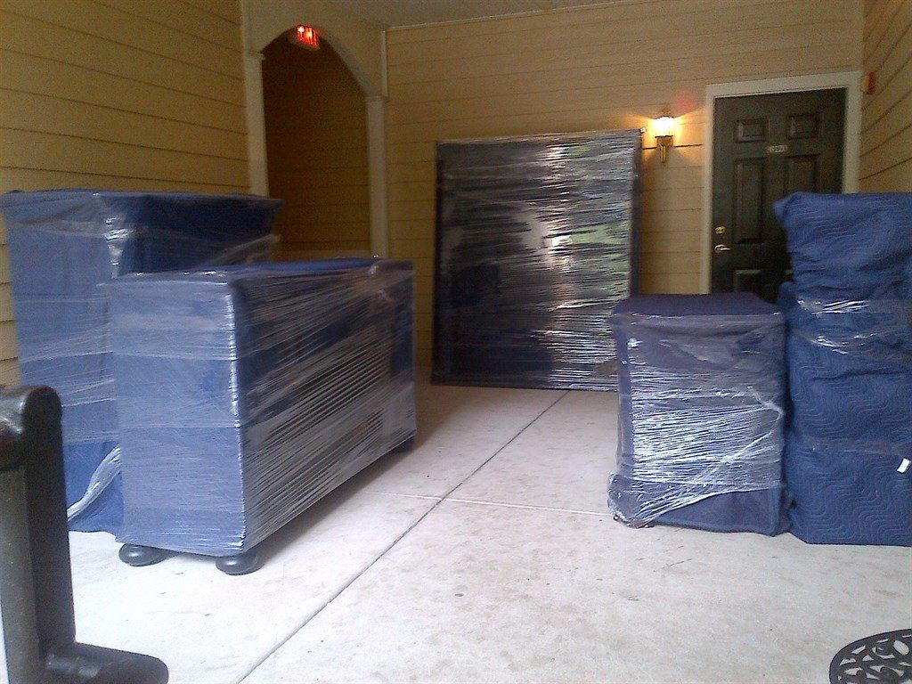 A room with a lot of boxes wrapped in blue plastic 28.4845° N, 81.2519° W