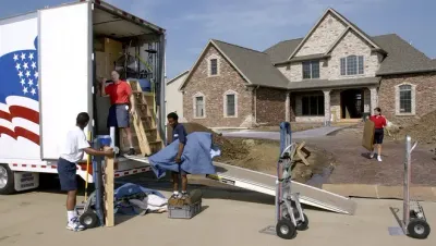 A moving truck is parked in front of a house 28.4845° N, 81.2519° W