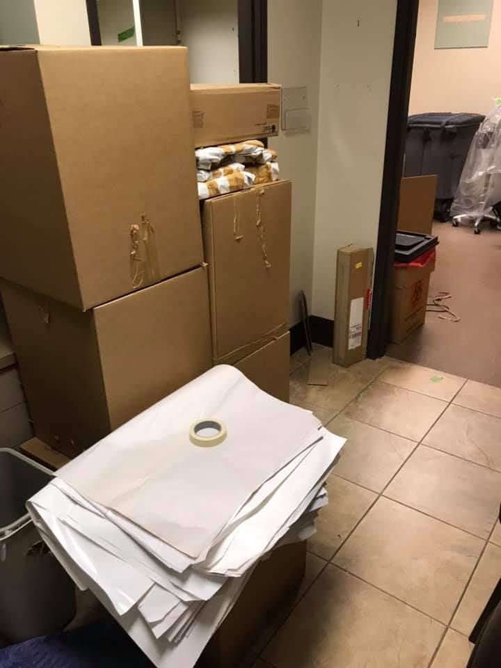 A room with a lot of boxes and papers on the floor 28.4845° N, 81.2519° W
