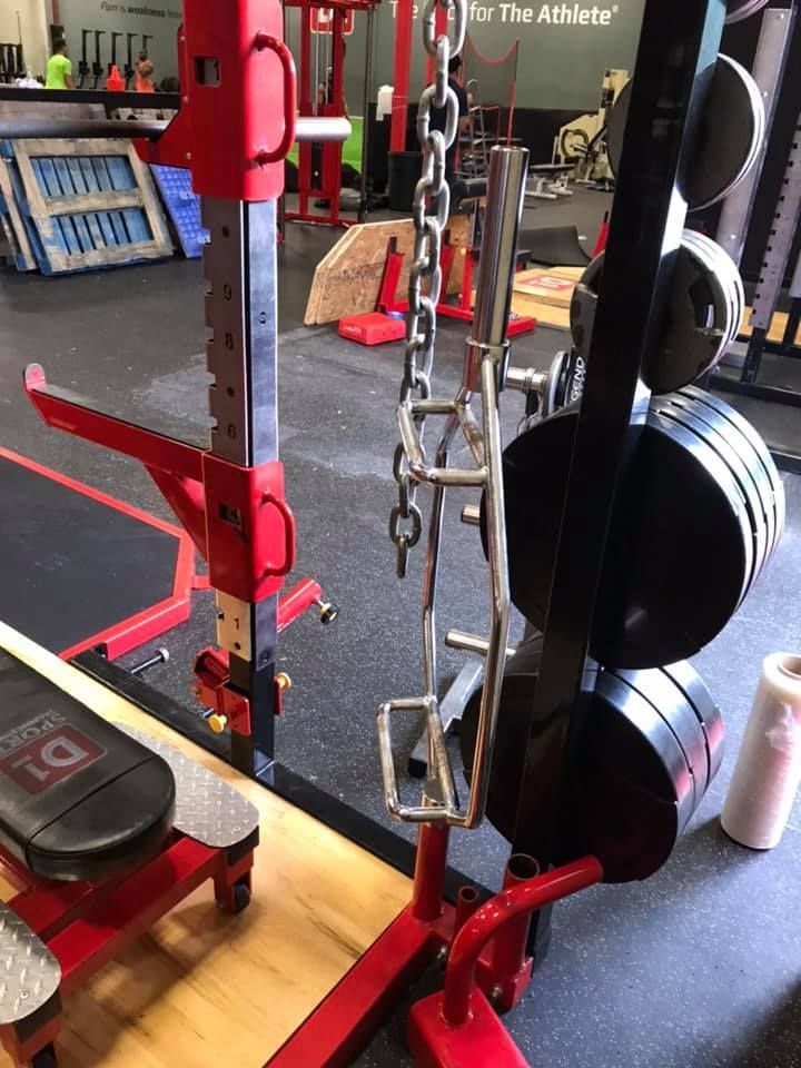A gym with a chain hanging from a barbell rack 28.4845° N, 81.2519° W