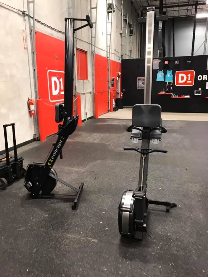 Two rowing machines are sitting next to each other in a gym. 28.4845° N, 81.2519° W