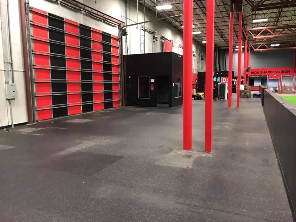 An empty warehouse with red and black walls and pillars 28.4845° N, 81.2519° W