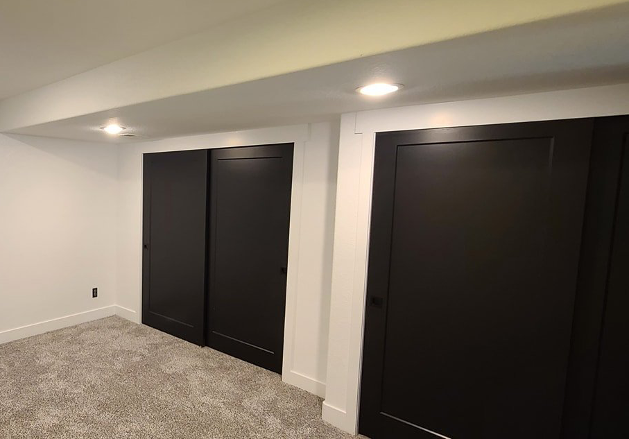 There are two black doors in the room.