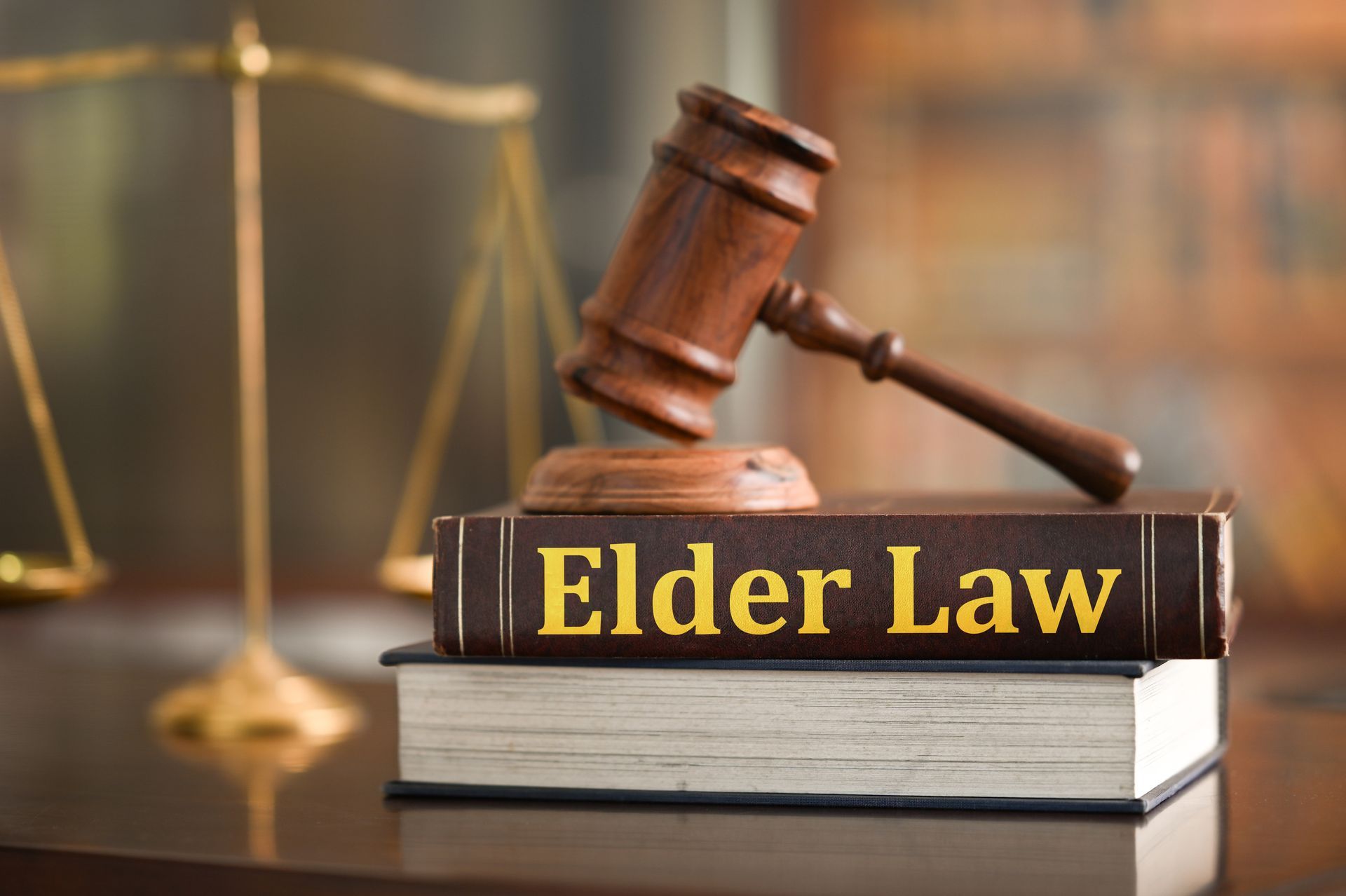 Judge's gavel resting on an elder law book, symbolizing legal services for older adults.