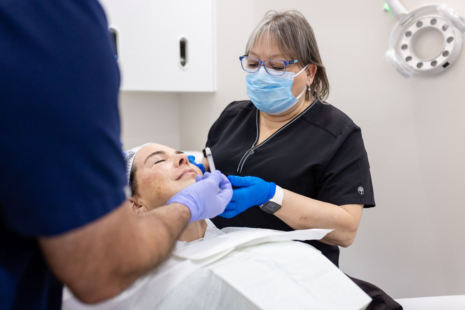 Dr. Paul Garcia treating a patient's face at CARE Esthetics in Davie, FL