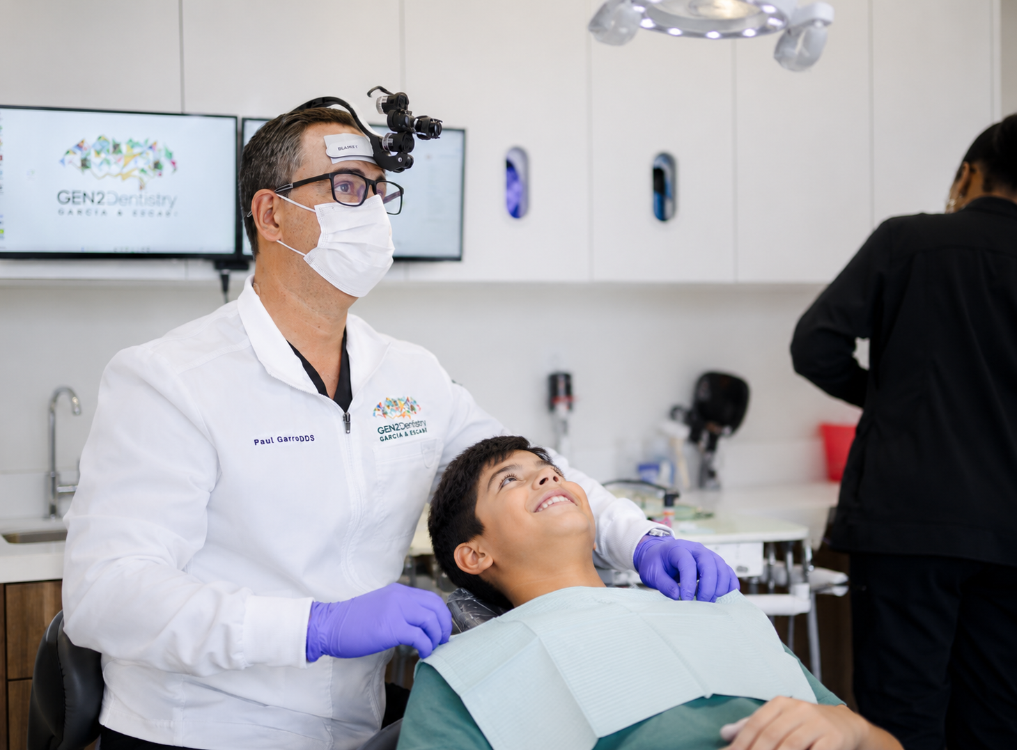 Dr. Paul Garcia examining a young patient's teeth at our Davie dental office