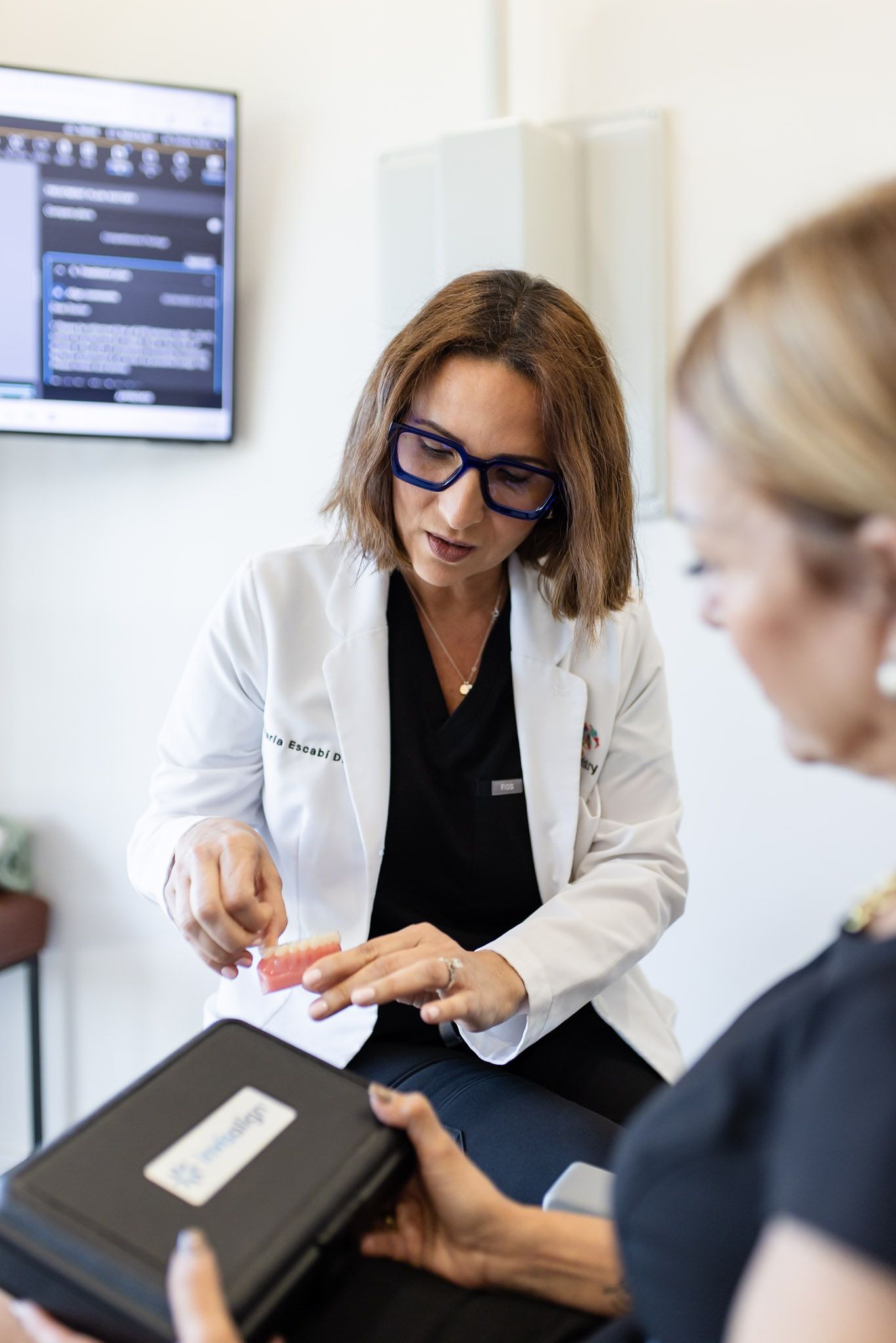 Dentist talking a patient through treatment options at GEN2 Dentistry in Davie, FL