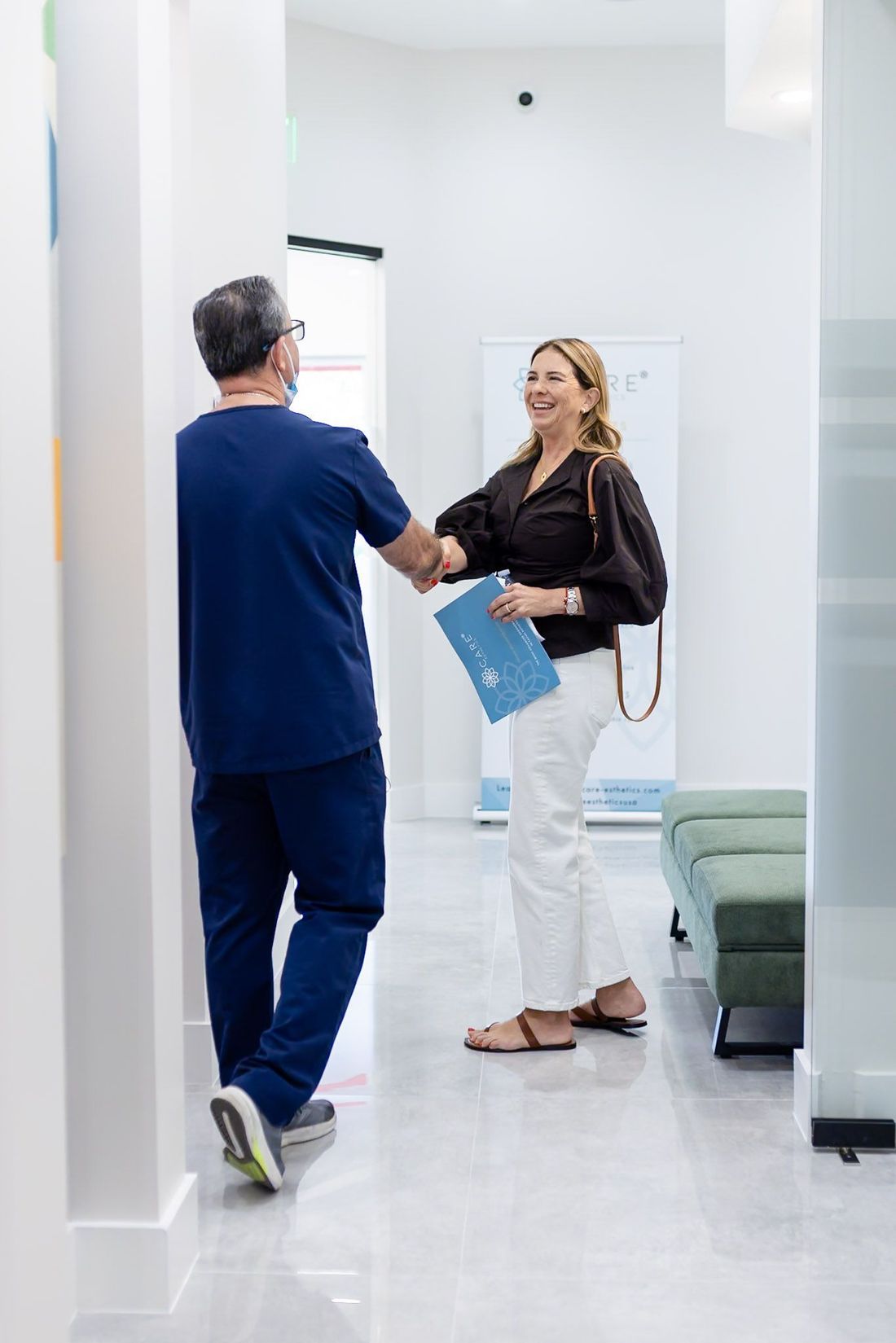A GEN2 Dentistry team member greeting a patient at the Davie dental office