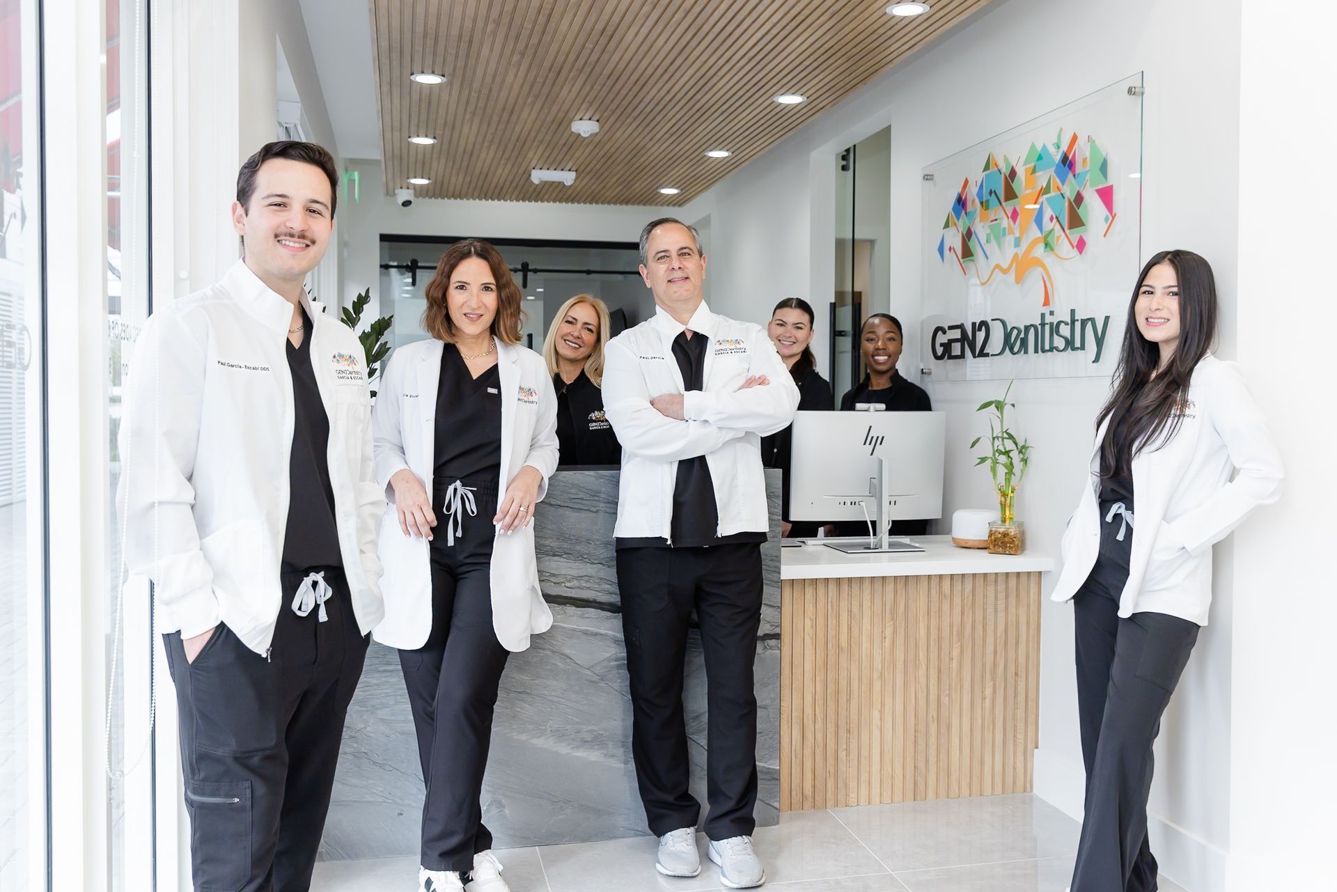 Dr. Escabí, Dr. Garcia and the GEN2 Dentistry team in the lobby
