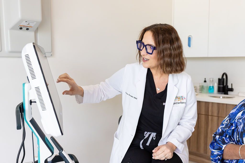 Dr. María Escabí reviewing a gum health scan at our Davie dental office