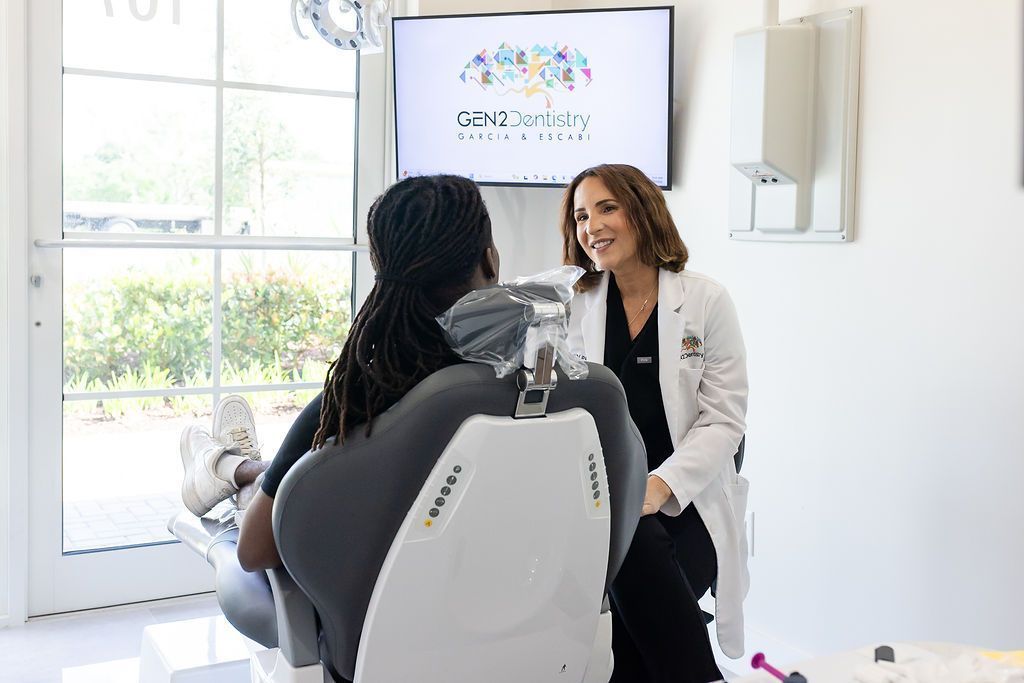 Dr. María Escabí with a patient in the operatory at our Davie dental office