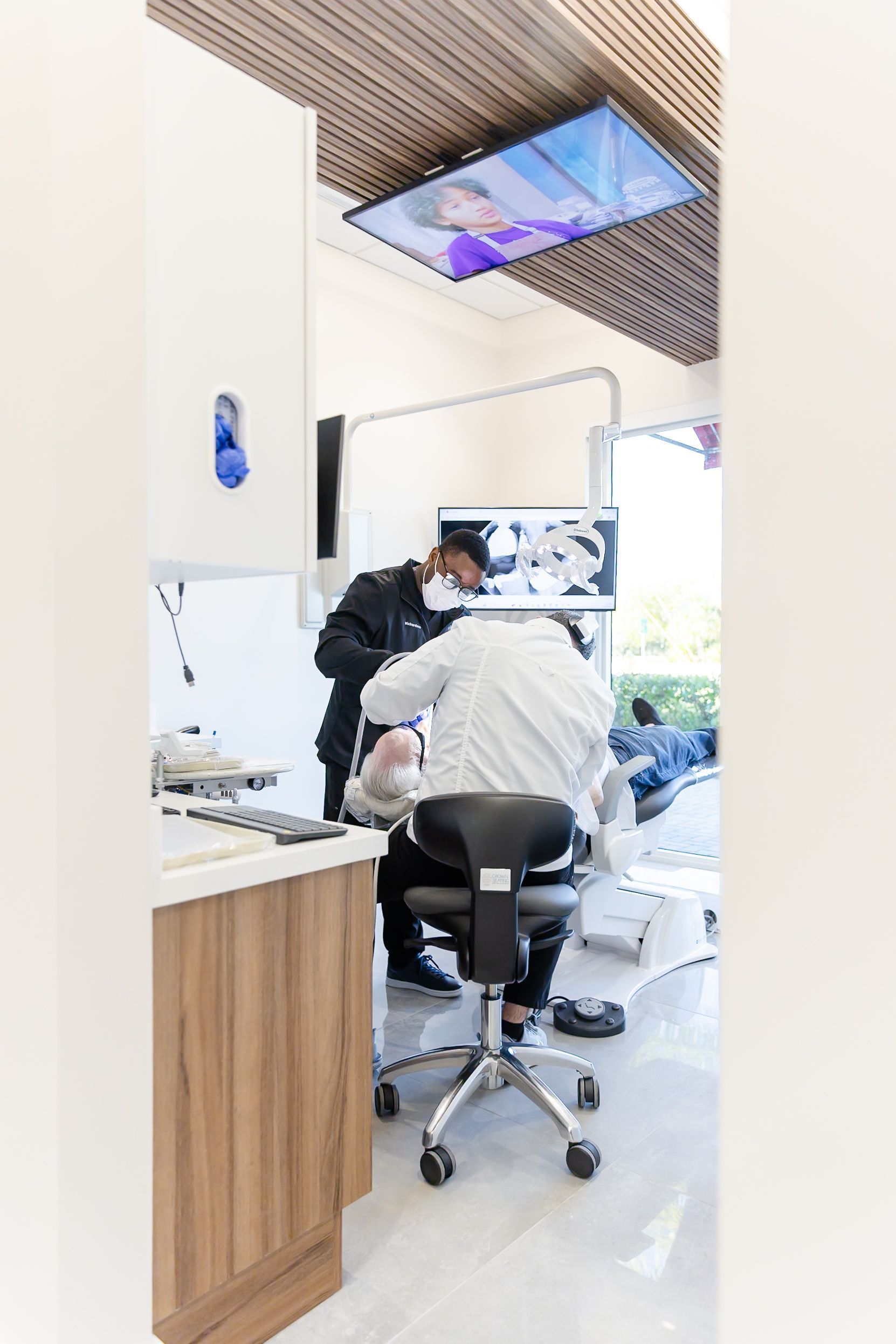 Dentist and patient in a bright operatory during root canal care
