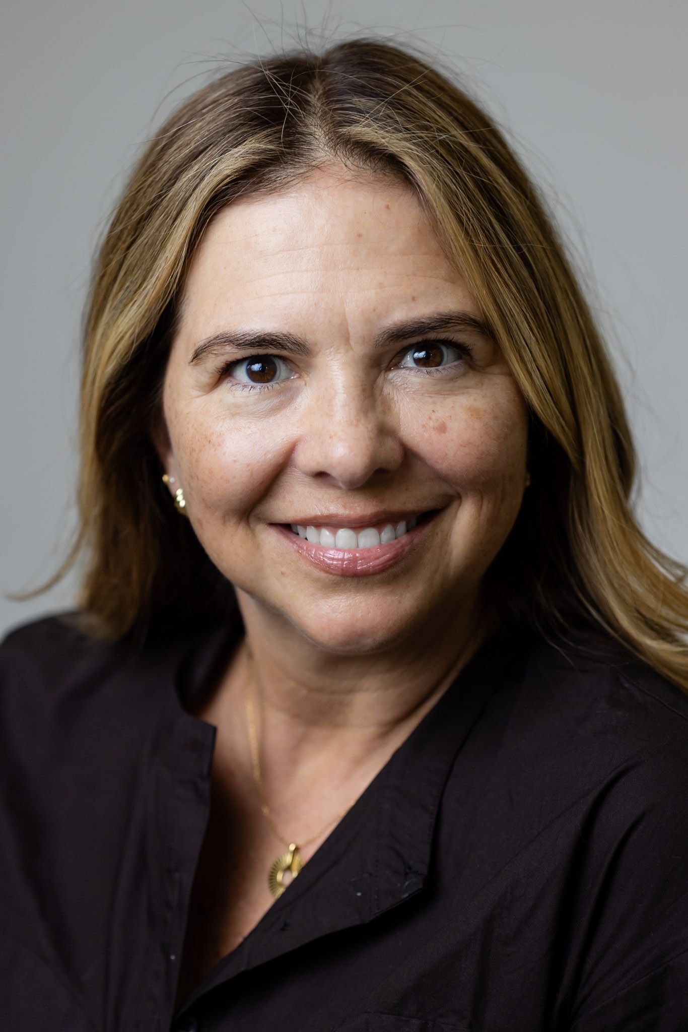 Portrait of a smiling woman with a confident, natural smile