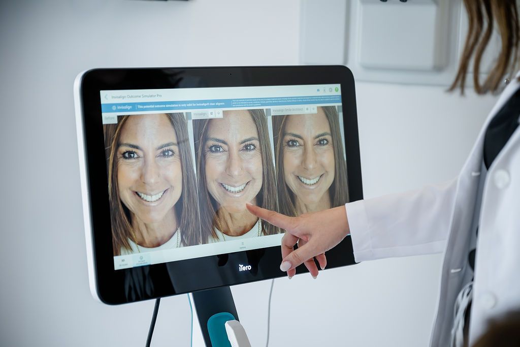 Digital smile design previews shown on a screen at GEN2 Dentistry