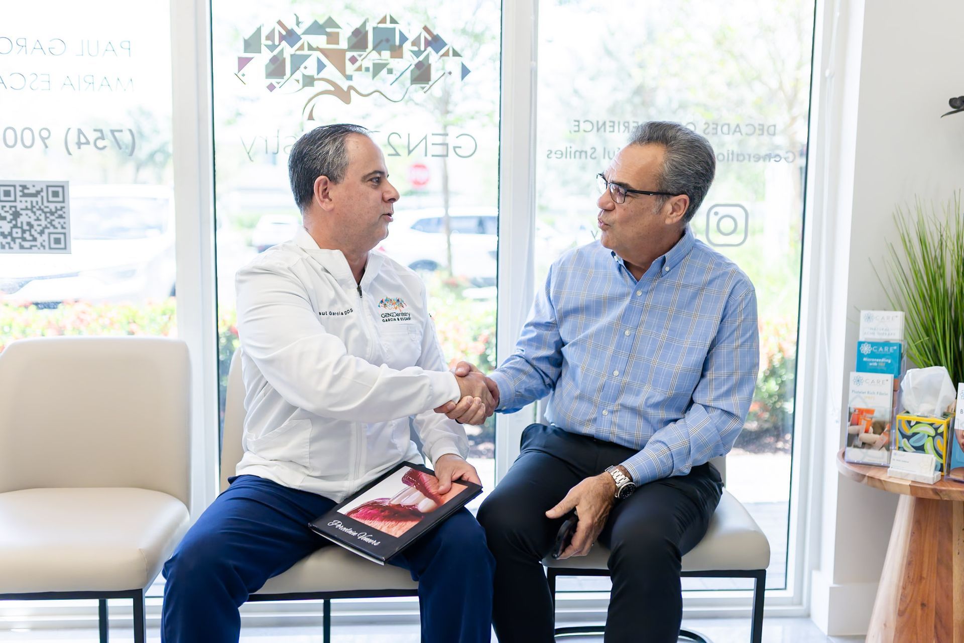 Dentist shakes a patient's hand, holding a veneers brochure, in Davie, FL
