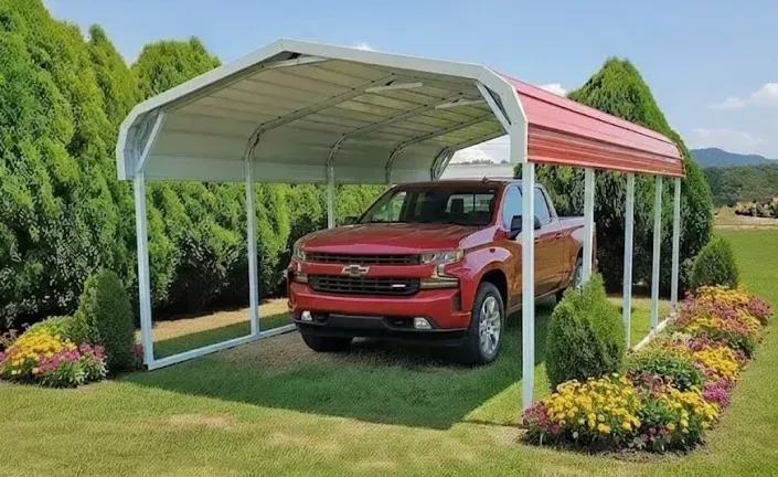 Red pickup truck parked under a white and red carport in a landscaped garden with flowers and green trees.