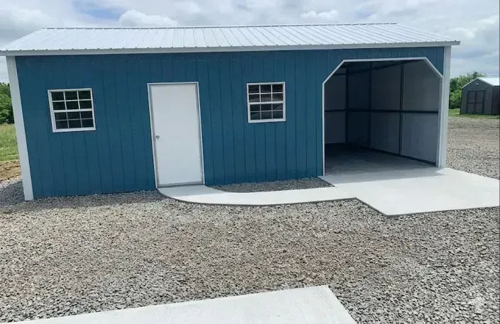 blue metal garage with walkway to side door