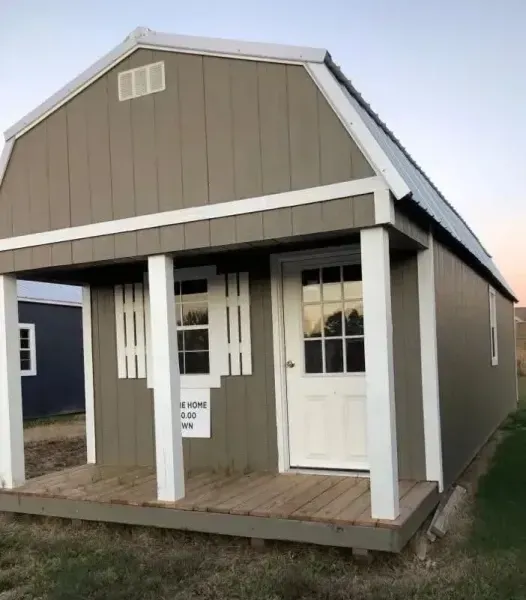 Small tan house with white trim and a front porch, shown from the front-left angle.