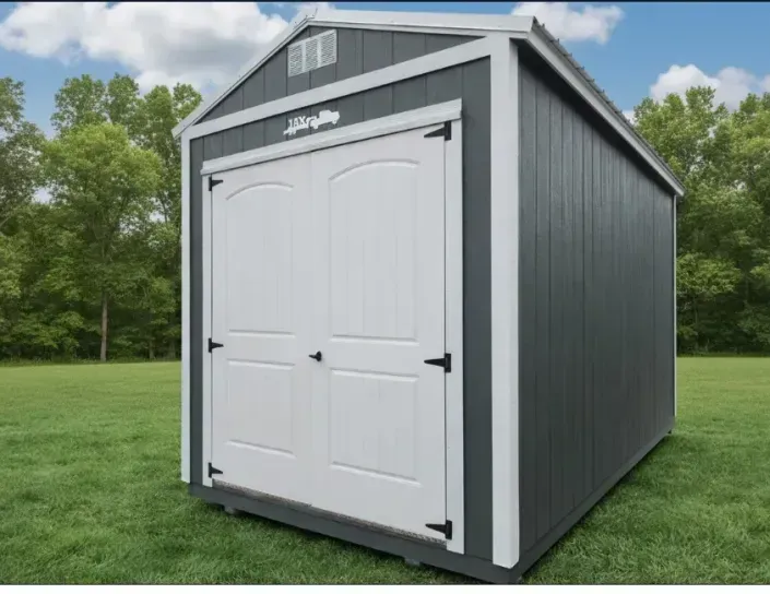 Gray outdoor storage shed with white double doors on a grassy lawn, beside trees
