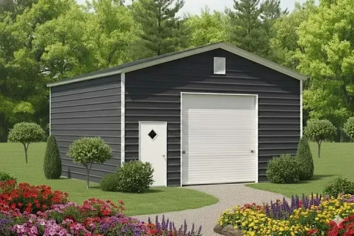 Dark gray garage with white doors and colorful flower beds in a landscaped yard