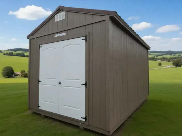 Brown garden shed with white double doors in a grassy field under a partly cloudy sky