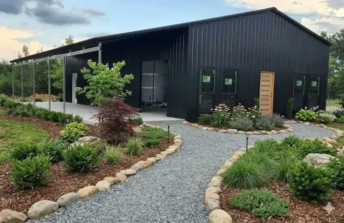 large black metal workshop with covered porch area