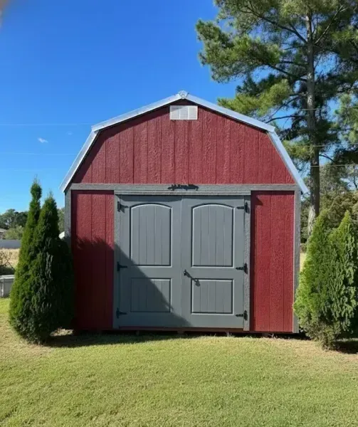 red lofted barn with grey trim and double doors