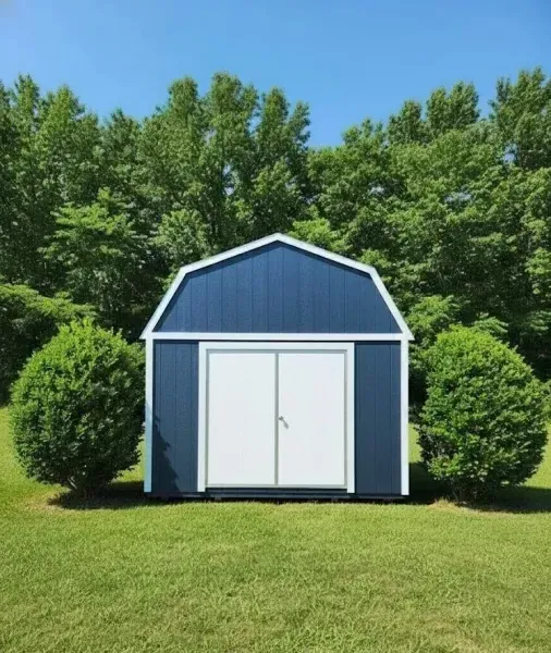 Bluelofted barn with white double doors on a grassy lawn, framed by two round bushes and trees.