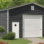 Dark gray garage with white door and small side entry door