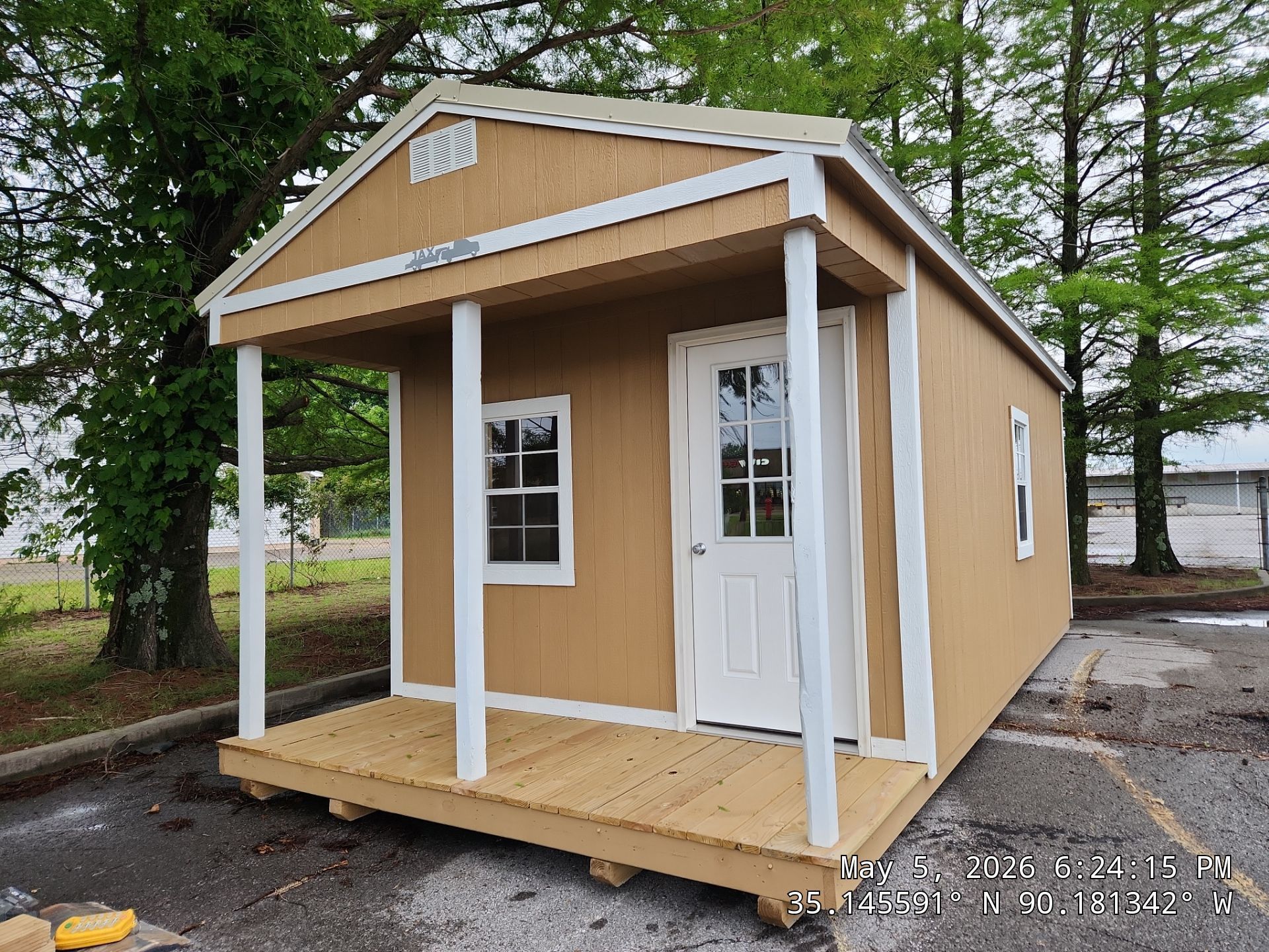 light brown cabin with front porch