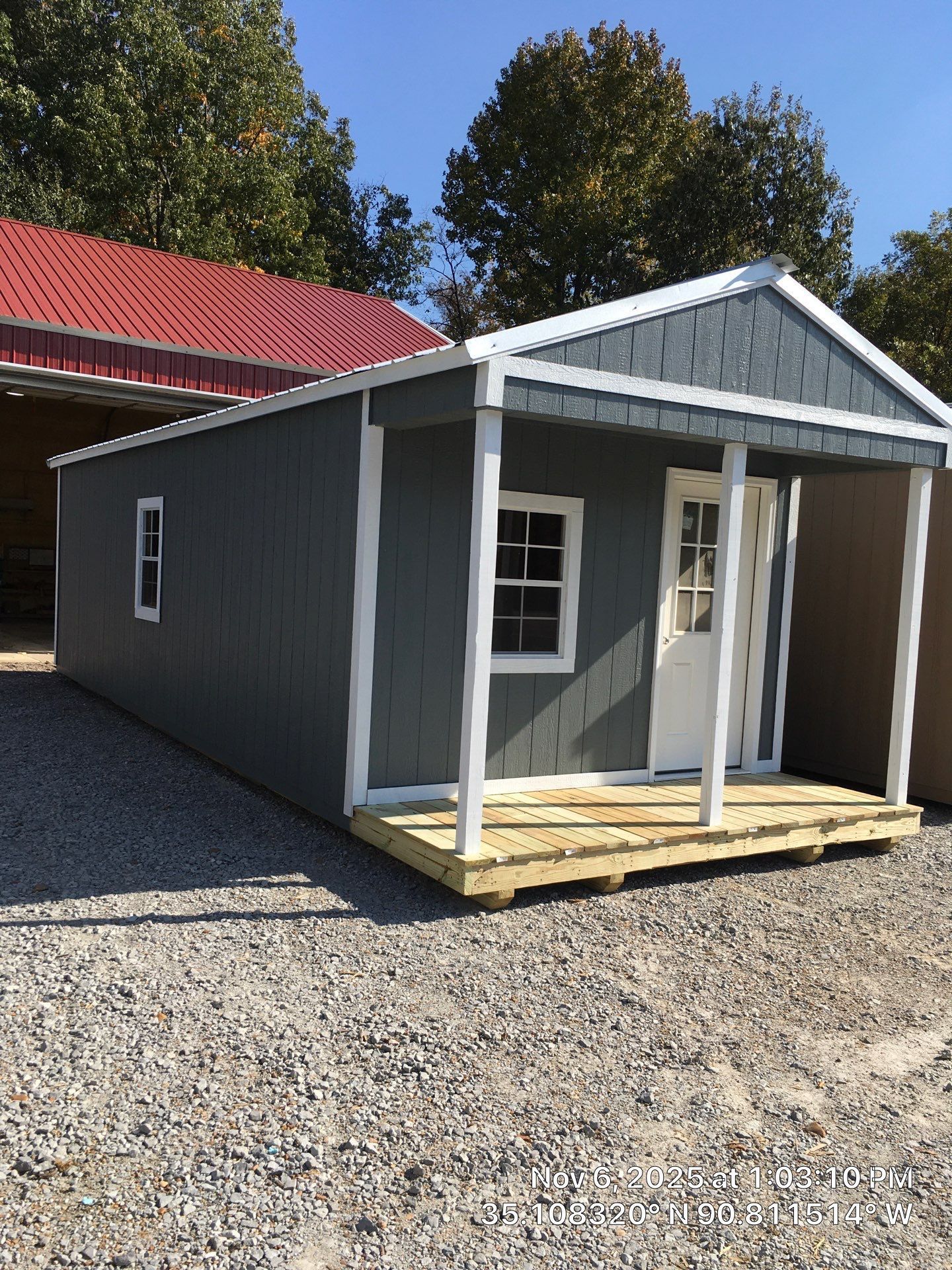 gray cabin with front porch and white trim