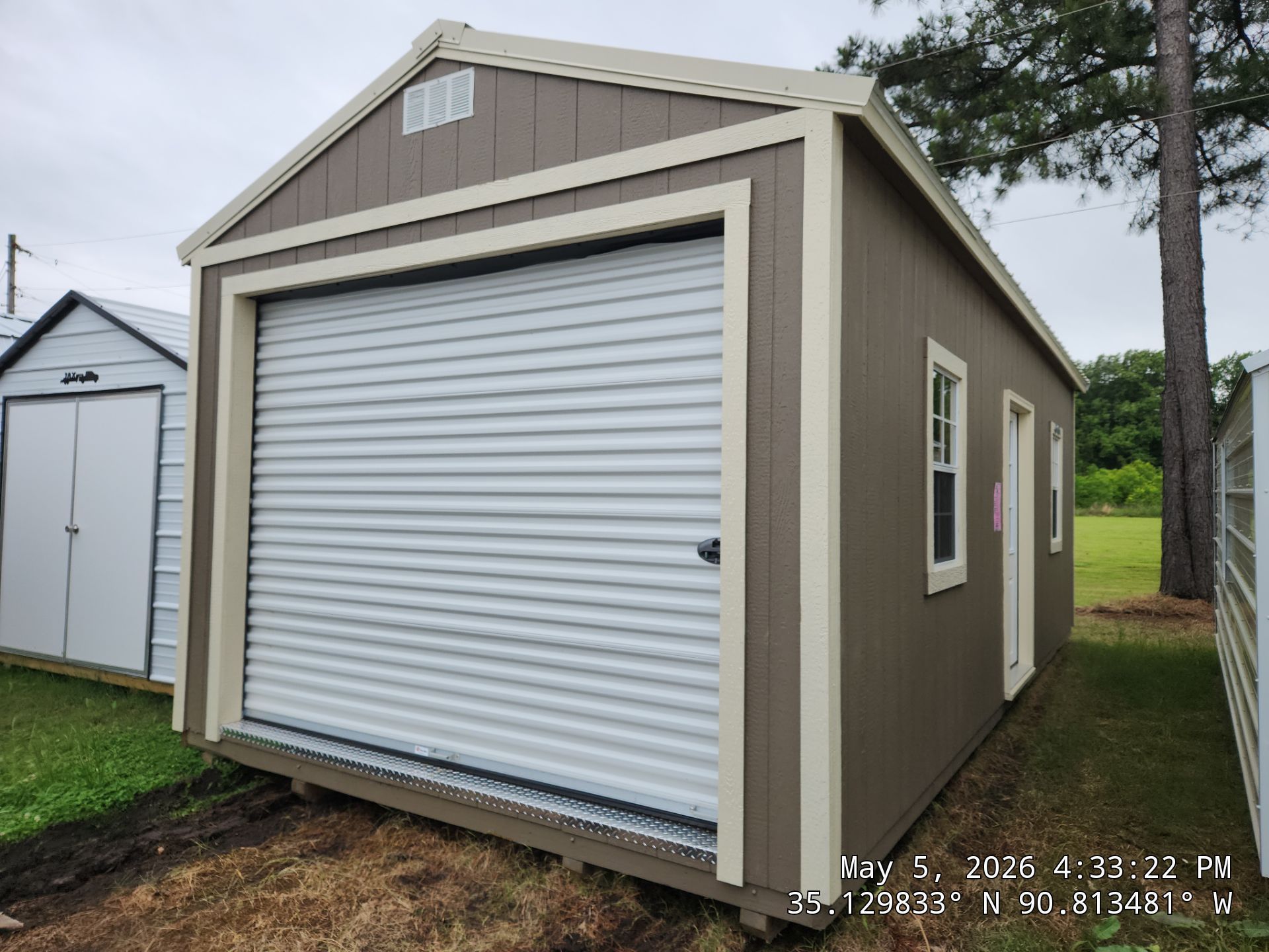 tan side garden shed with roll up door