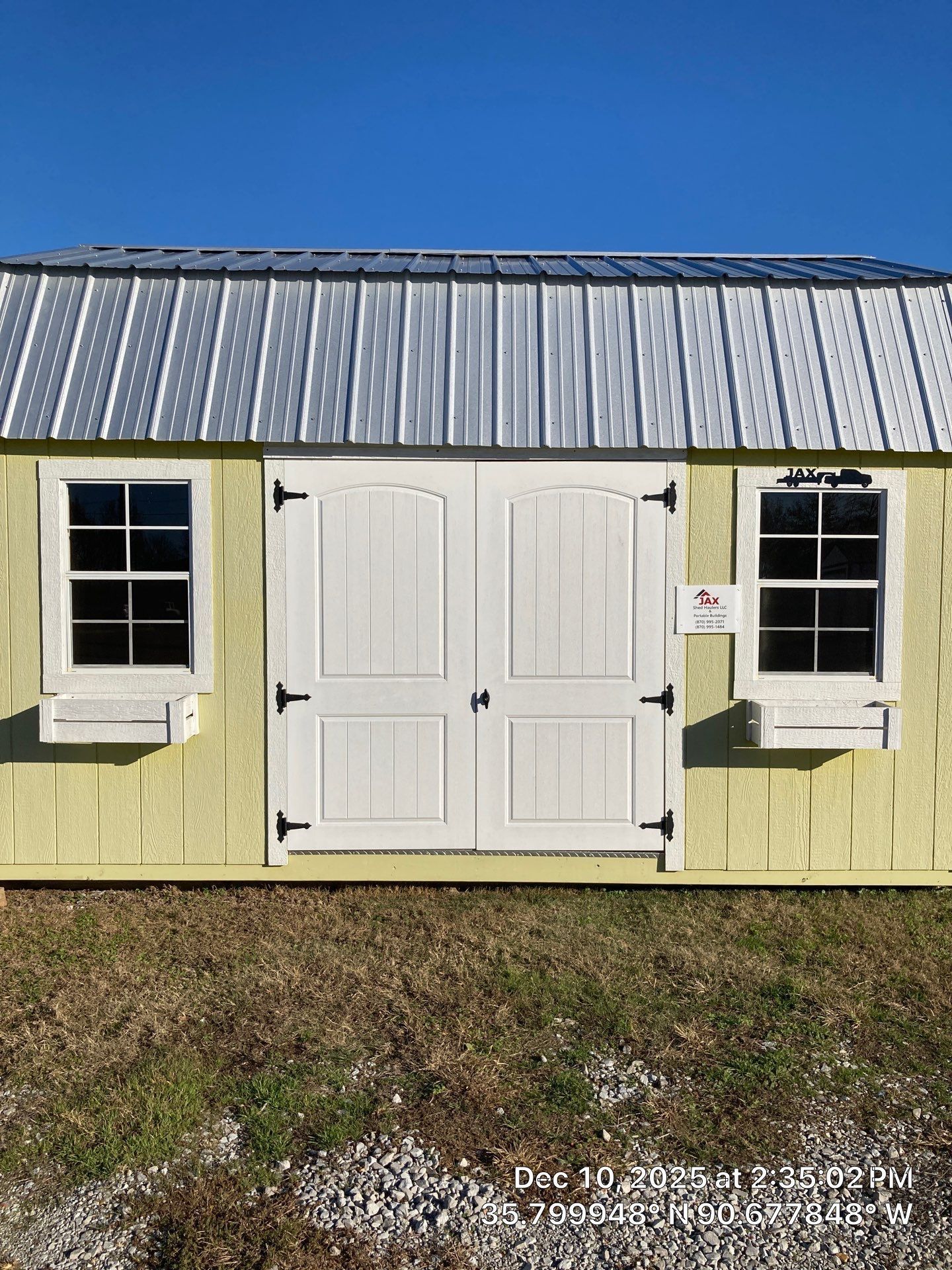 side lofted barn with double doors and window planter boxes