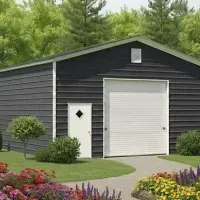 Dark gray metal shop with white roll-up door, side entry, and landscaped garden in front