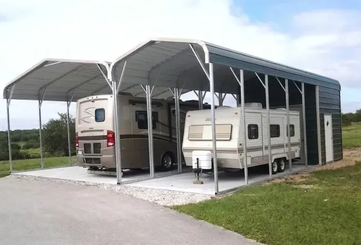 Covered RV parking with two motorhomes under a gray metal carport