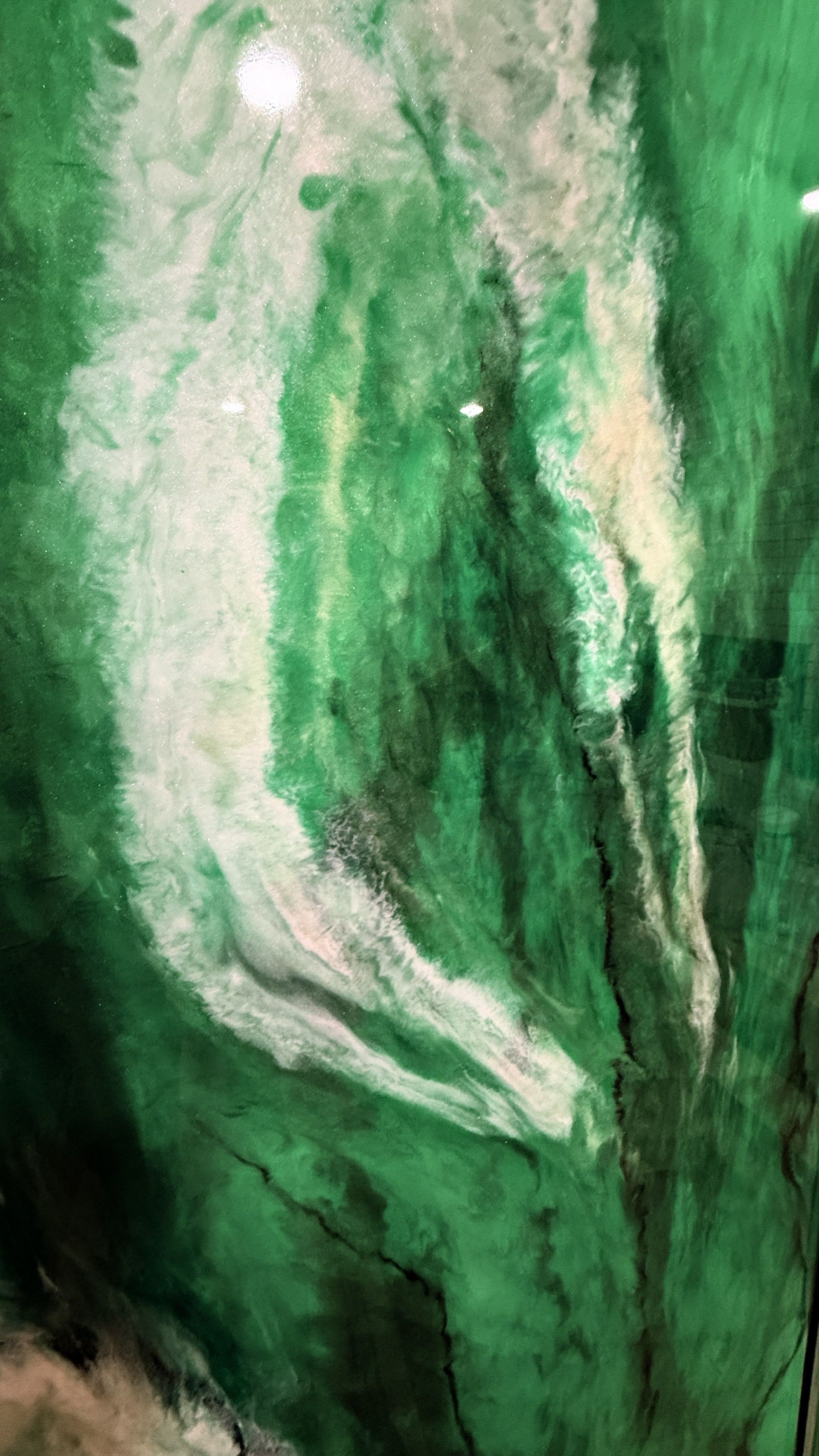 Abstract green and white watercolor-like texture with flowing brushstrokes