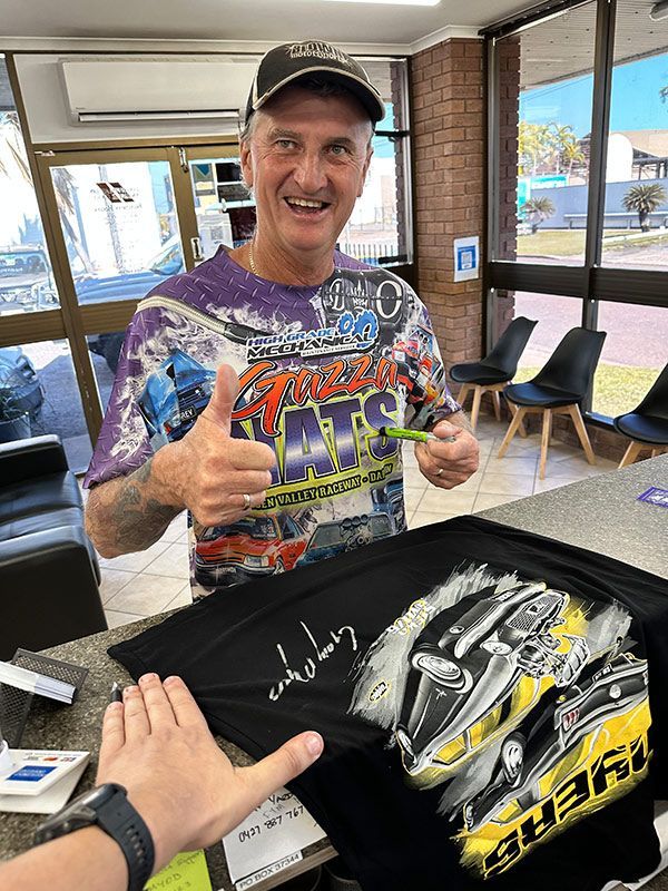 Man is Signing a T-shirt in a Store — Darwin Auto Mobile Care in Woolner, NT
