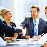 Two businessmen handshaking after striking grand deal