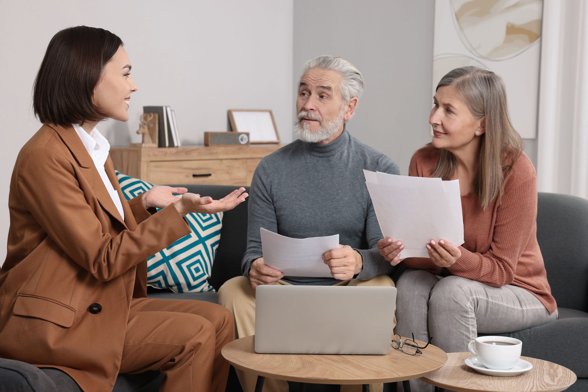 Estate planning attorney consulting with older couple reviewing legal documents