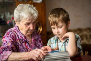 Grandma shows grandson photo album.
