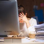 Young and beautiful businesswoman tired from work in the office.