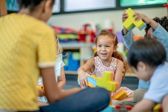 Little Girl Playing With Toys — Tuscaloosa, AL — Tender Loving Care Little Girl Playing With Toys — Tuscaloosa, AL — Tender Loving Care