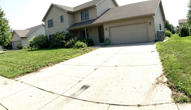 A freshly poured, smooth concrete driveway with excellent curb appeal