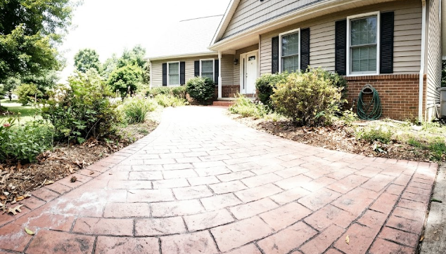 Decorative stamped concrete walkway leading to a house entrance