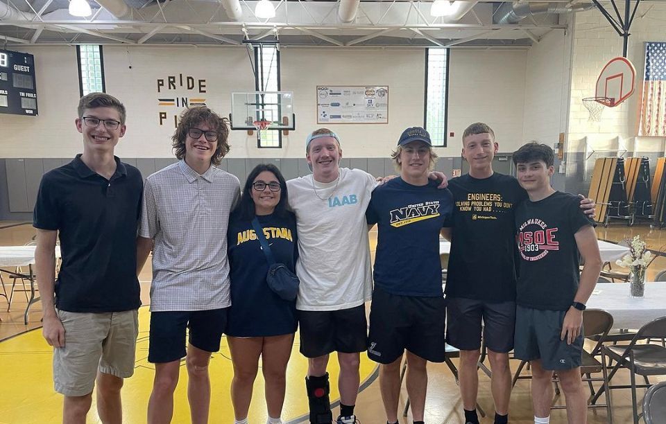 A group of young people are posing for a picture in a gym.