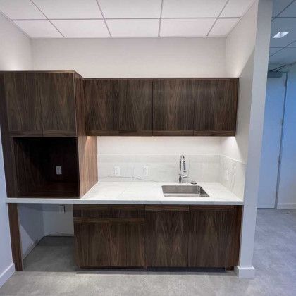A kitchen with wooden cabinets and a sink.